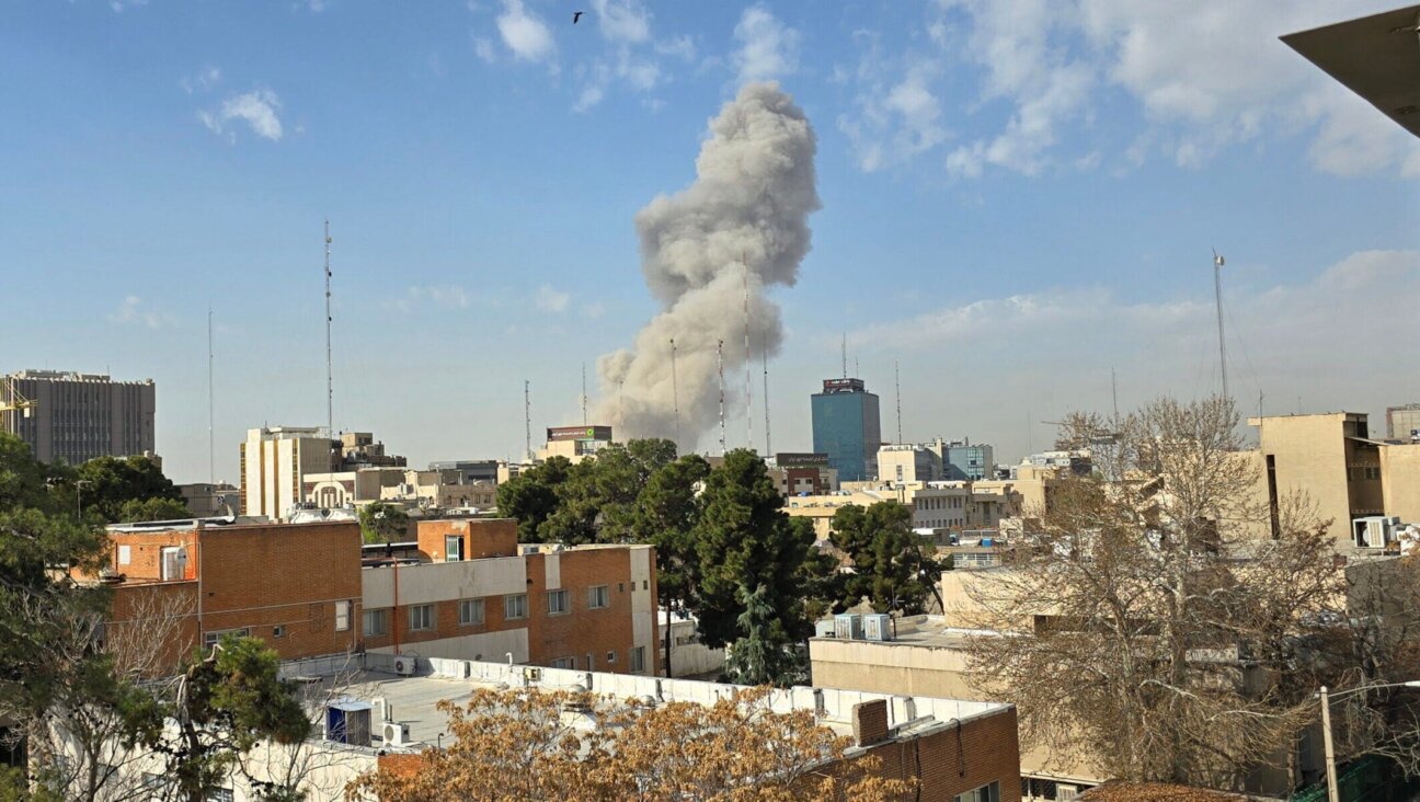 A plume of smoke rises after an explosion on Feb. 28, 2026 in Tehran as U.S. and Israeli forces launch a strike on Iran.(Majid Saeedi/Getty Images)
