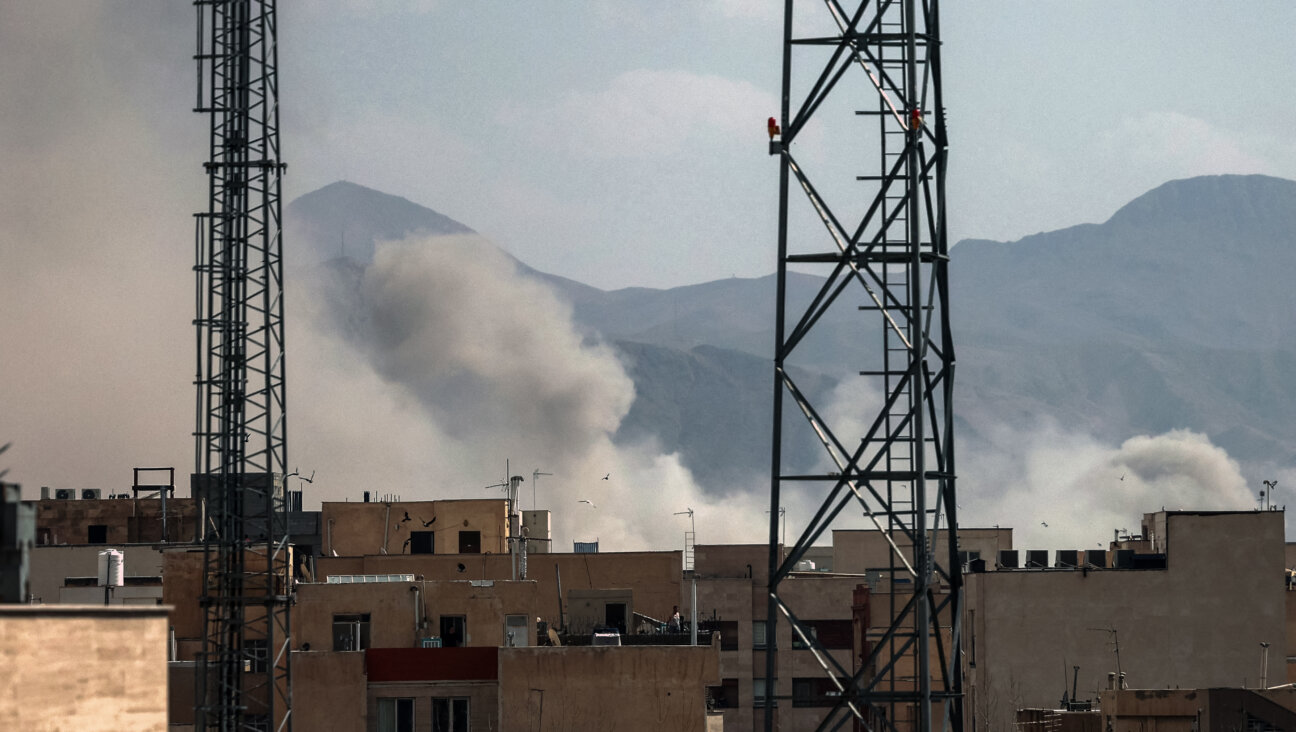A plume of smoke rises following a reported explosion in Tehran on February 28, 2026. Iran said on February 28 it will "respond decisively" after Israel and the United States launched strikes on the country despite talks underway on Tehran's nuclear programme. (Photo by AFP via Getty Images)