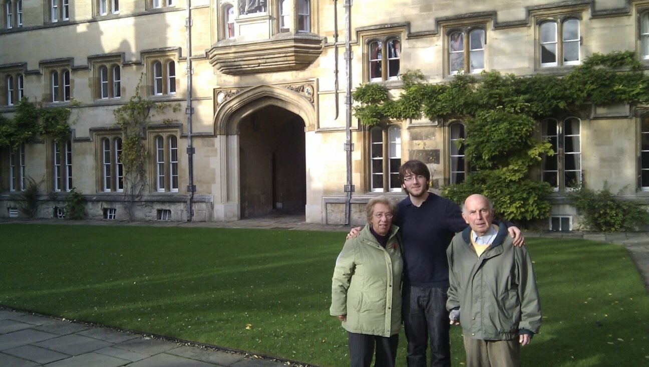Alex Margolis is flanked by his grandparents, Eva and Zvi Schloss, during a visit to the University of Oxford sometime before Zvi Schloss’ death in 2016. 