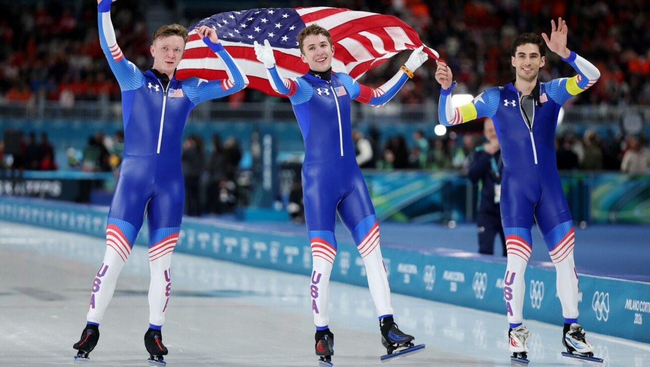 (L-R) Ethan Cepuran, Casey Dawson and Emery Lehman of Team United States celebrate after winning silver in the Speed Skating Men’s Team Pursuit on day eleven of the Milano Cortina 2026 Winter Olympic games at Milano Speed Skating Stadium on Feb. 17, 2026 in Milan. (Jamie Squire/Getty Images)