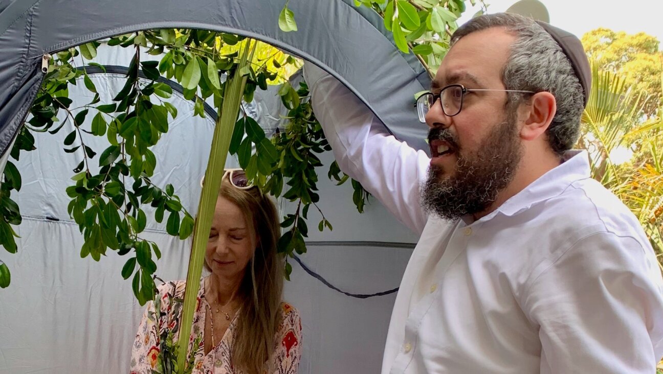 Nikki Goldstein and Rabbi Eli Schlanger celebrate Sukkot. 