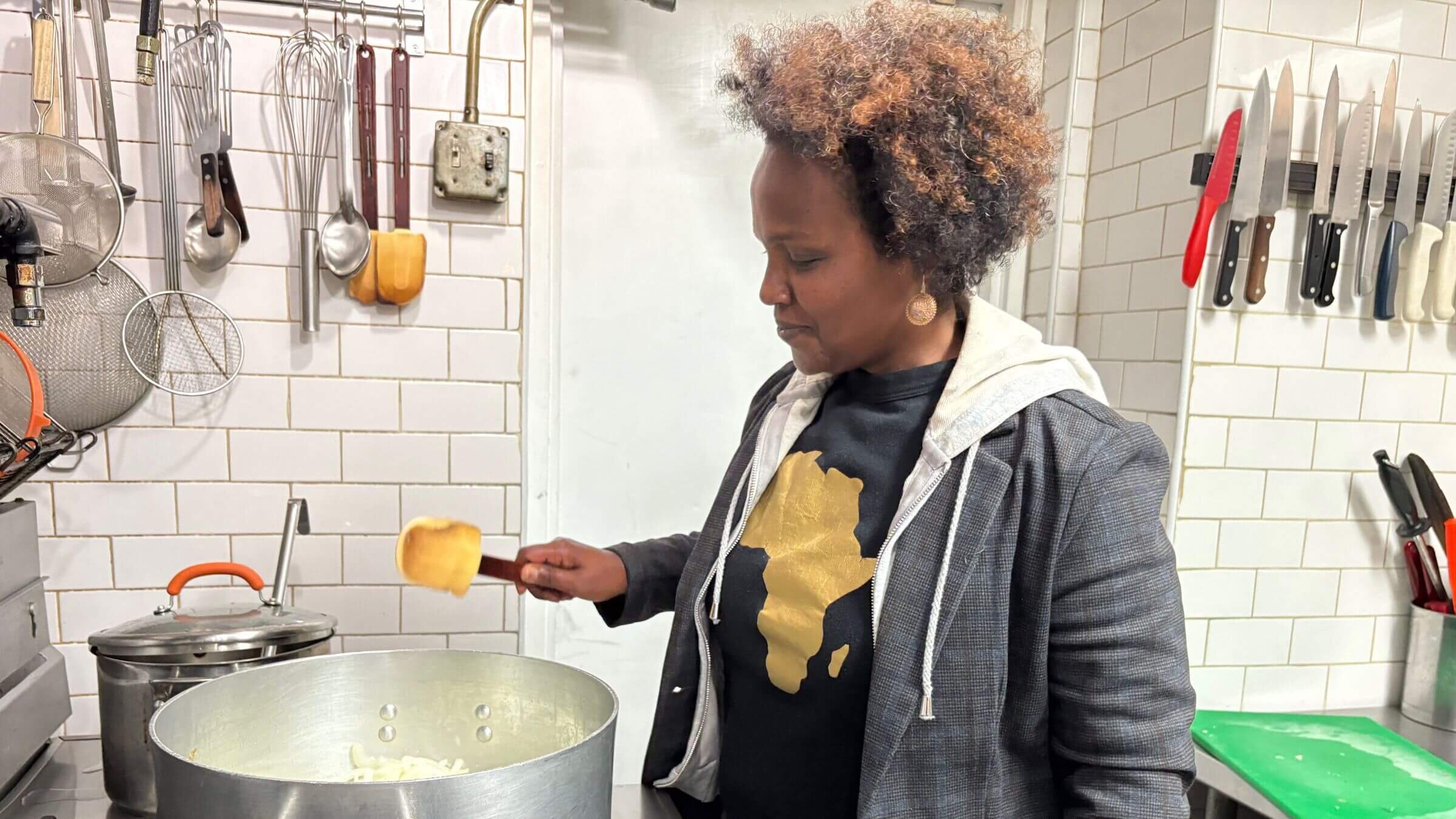 Beejhy Barhany cooking at Tsion Cafe in Harlem, New York