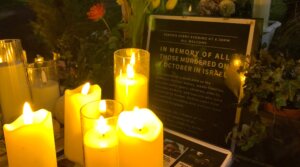 A photograph taken on Jan. 18, 2025 shows lit candles and a placard displayed during a vigil in the centre of Brighton, England, for people held hostage by Palestinian militant group Hamas in Gaza. (Julie EZVAN / AFP)