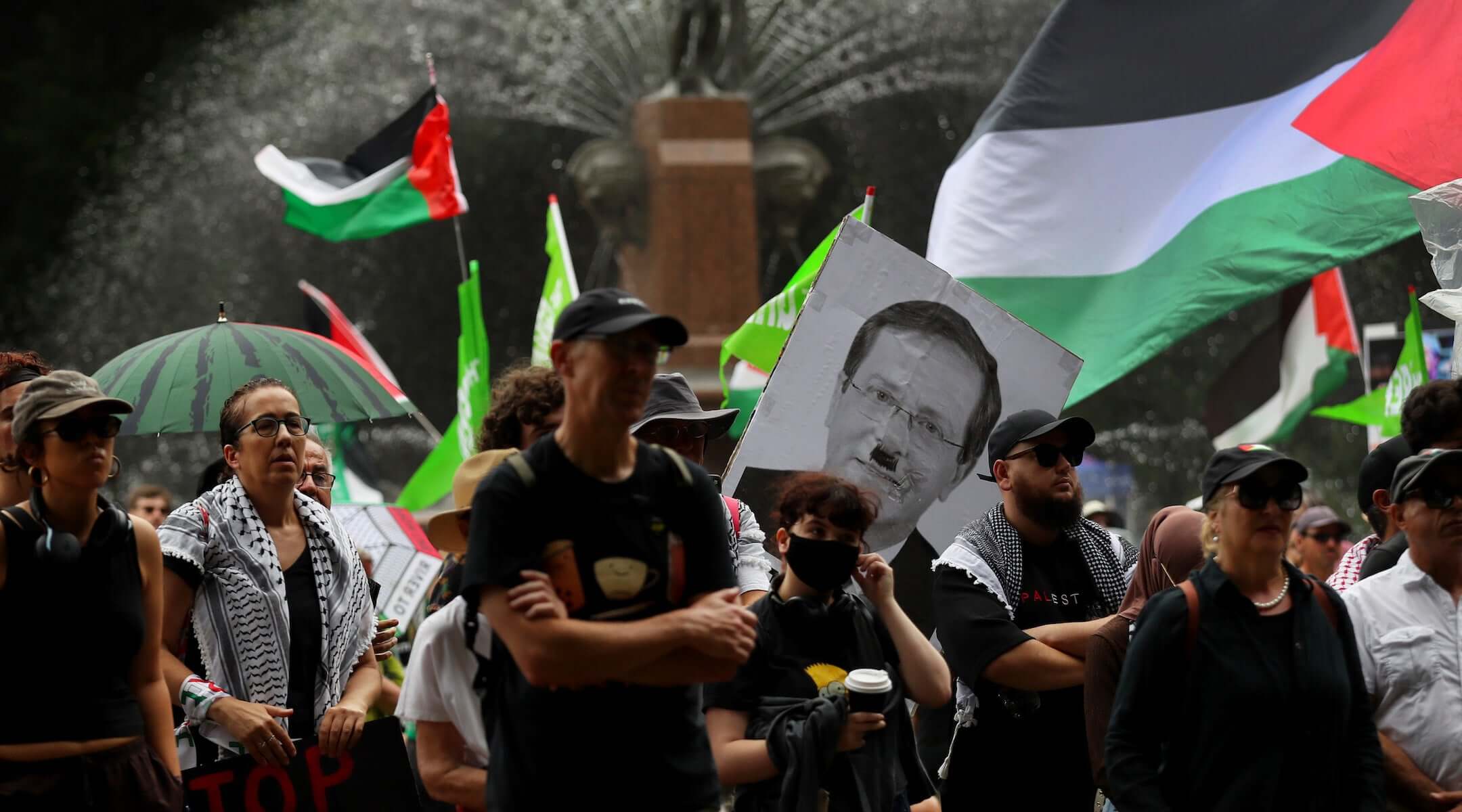 Protesters carry flags and placards during a rally against Israeli President Isaac Herzog’s upcoming Australian visit on Feb. 1, 2026 in Sydney.