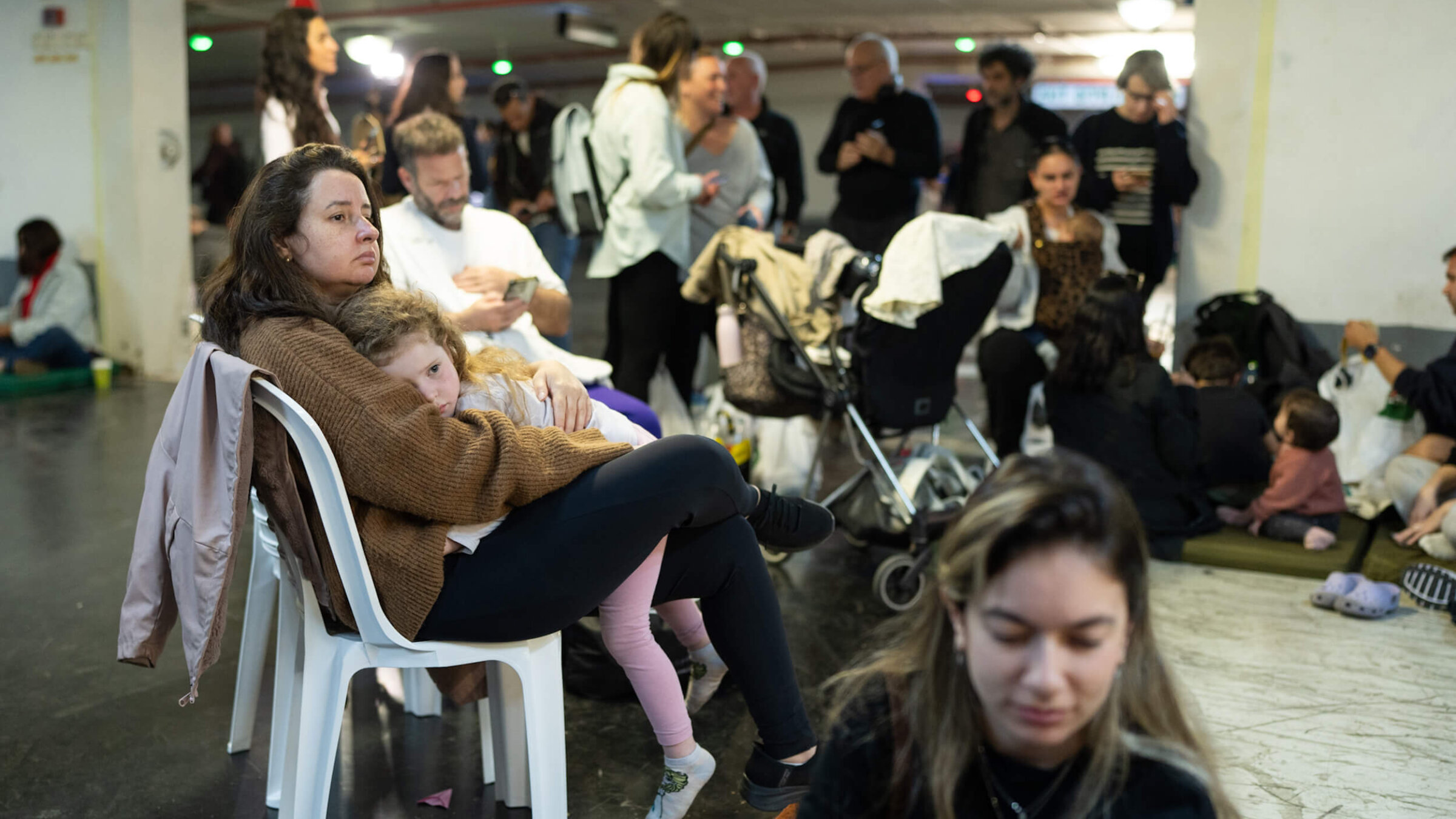 People take shelter in a parking garage in Tel Aviv, Israel amid reports of incoming missiles on Feb. 28. The country's Defense Minister Israel Katz declared a state of emergency this morning after Israel and the U.S. launched joint strikes on Iran, prompting Iran to launch a wave of missiles at Israel.