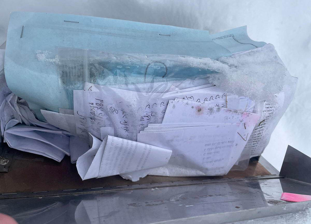 Visitors leave letters at the grave of Rabbi Yechiel Meir Burgeman in Rochester, New York.