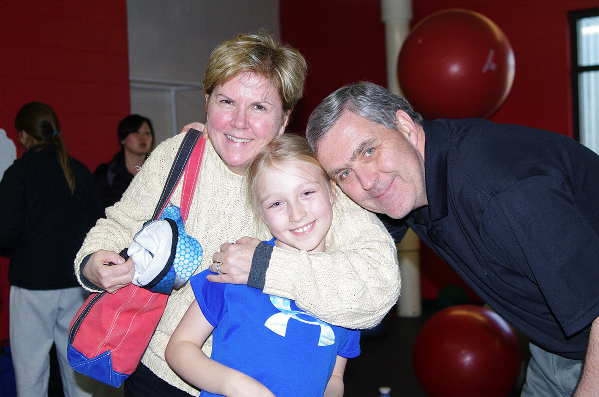 Kamryn Lute, center, with her mom Jane and dad Douglas at a speed skating tournament in 2012.