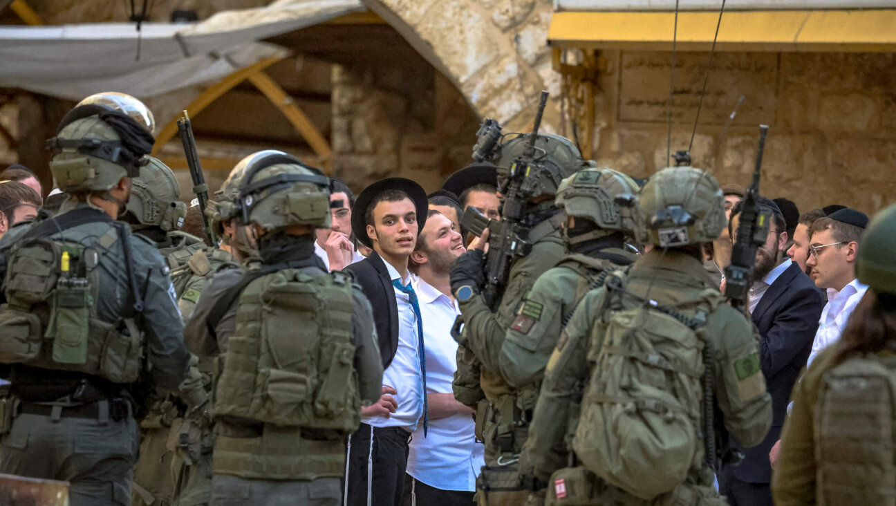 Israeli soldiers escort Israeli settlers as they walk through the Old City of Hebron in the occupied West Bank on Jan. 30.