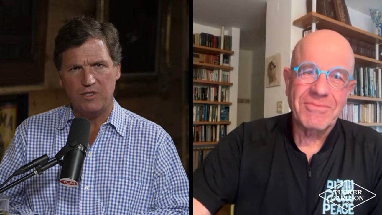 Right-wing pundit Tucker Carlson (l) hosts Israeli leftist, former interim president and former speaker of the Knesset, Avraham Burg, on his program, March 23, 2026.(Screenshot via YouTube)