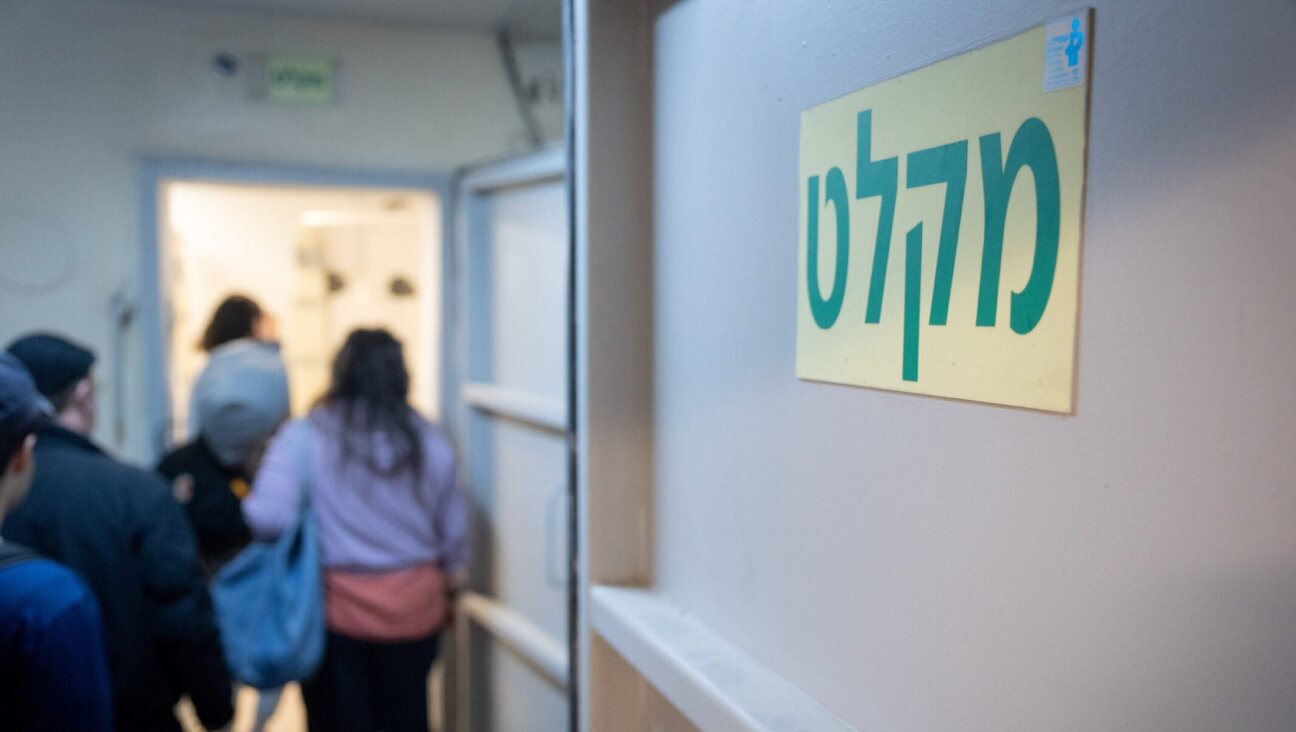 Israelis take cover in Tel Aviv as a siren sounds warning of incoming ballistic missiles fired from Iran toward Israel, March 1, 2026.