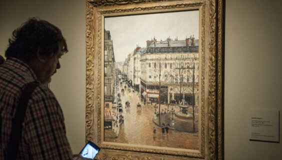  Museum goer looks at Pissarro's 'Rue Saint-Honore in the Afternoon. Effect of Rain' at the Thyssen-Bornemisza Museum in Madrid. 
