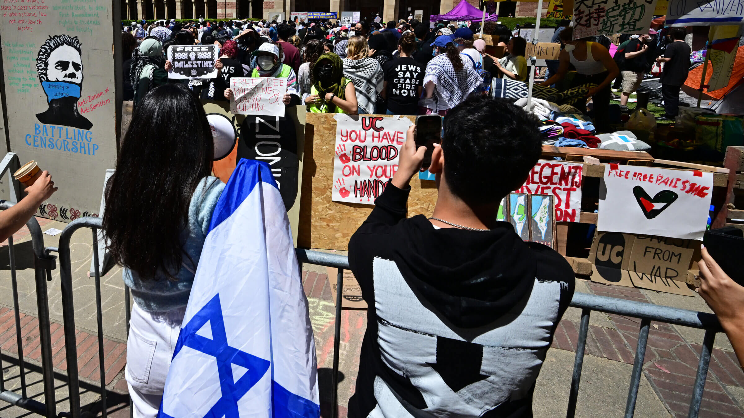 Pro-Israel and pro-Palestinian students face off at an encampment on the campus of the University of California Los Angeles (UCLA), in Los Angeles on April 26, 2024.