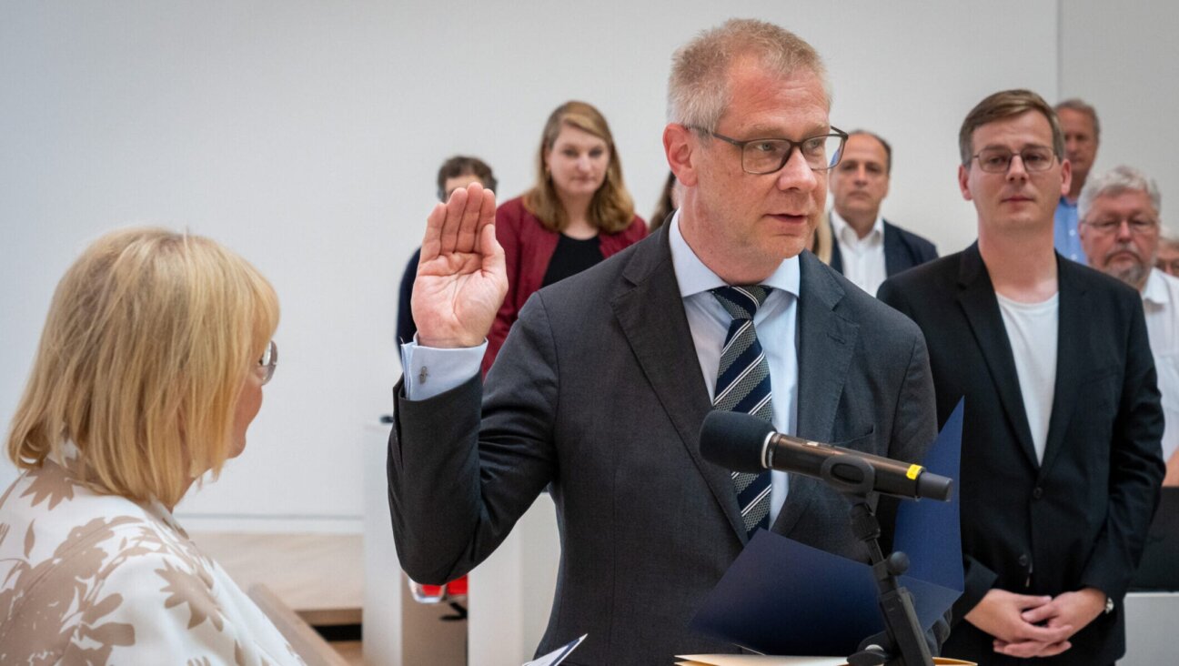 German politician Andreas Büttner is sworn in during the state parliament session following his election as Brandenburg’s anti-Semitism commissioner, with members of his Left party in the background, June 20 2024.