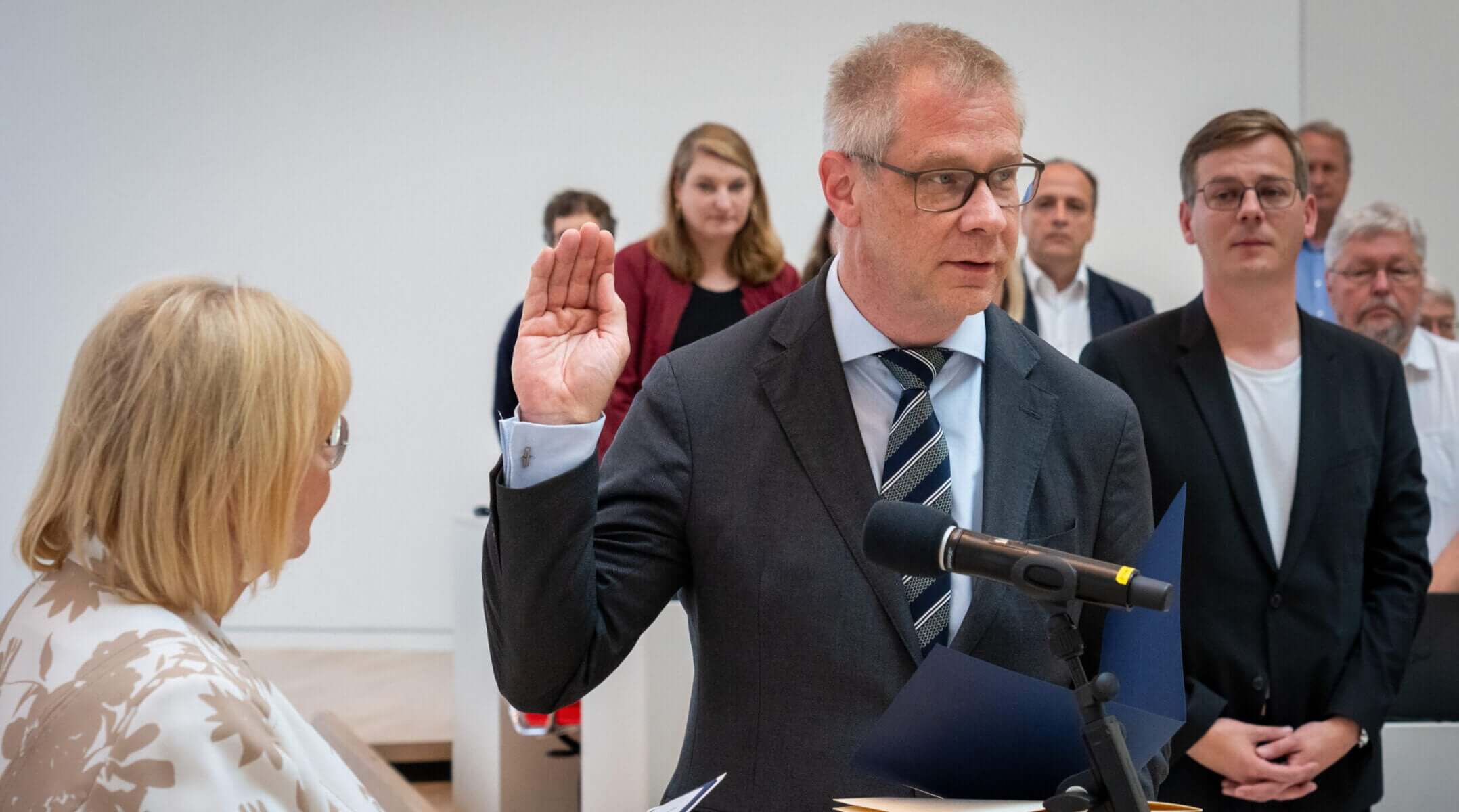 German politician Andreas Büttner is sworn in during the state parliament session following his election as Brandenburg’s anti-Semitism commissioner, with members of his Left party in the background, June 20 2024.