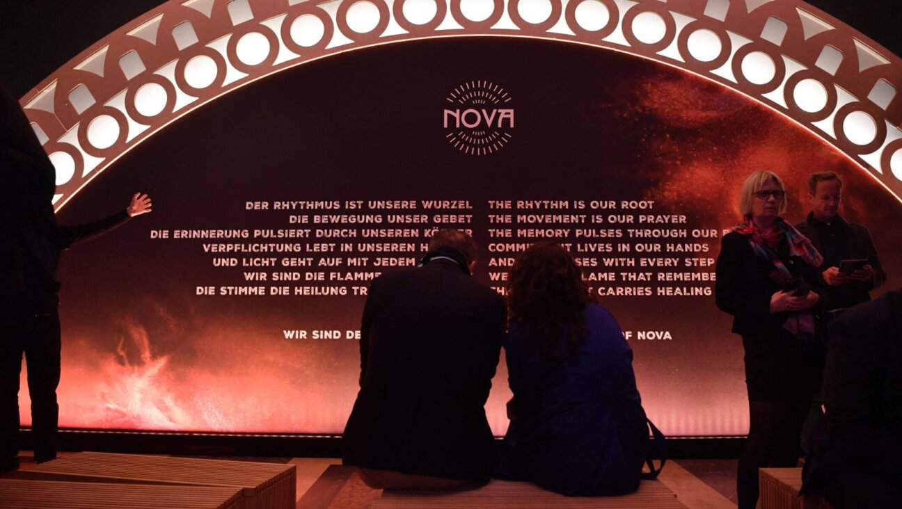Visitors sit at the opening of the "Nova Music Festival Exhibition" in the former Tempelhof Airport in Berlin on Oct. 5, 2025.