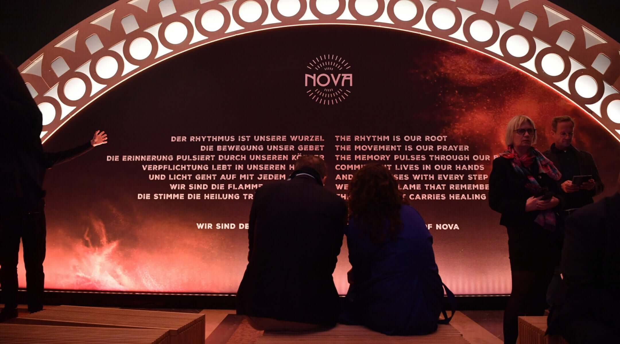 Visitors sit at the opening of the "Nova Music Festival Exhibition" in the former Tempelhof Airport in Berlin on Oct. 5, 2025.