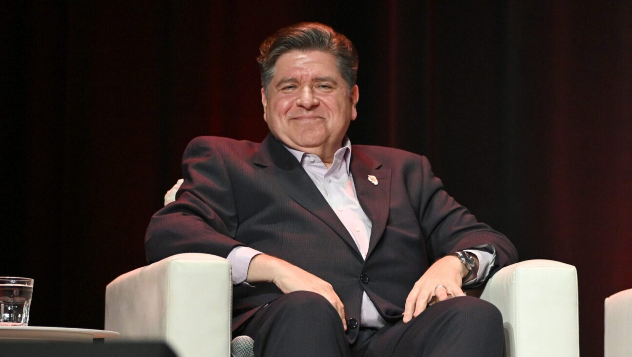 Illinois Gov. JB Pritzker speaks on stage at The Chicago Theatre on November 12, 2025.