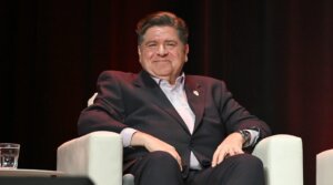 Illinois Gov. JB Pritzker speaks on stage at The Chicago Theatre on November 12, 2025.
