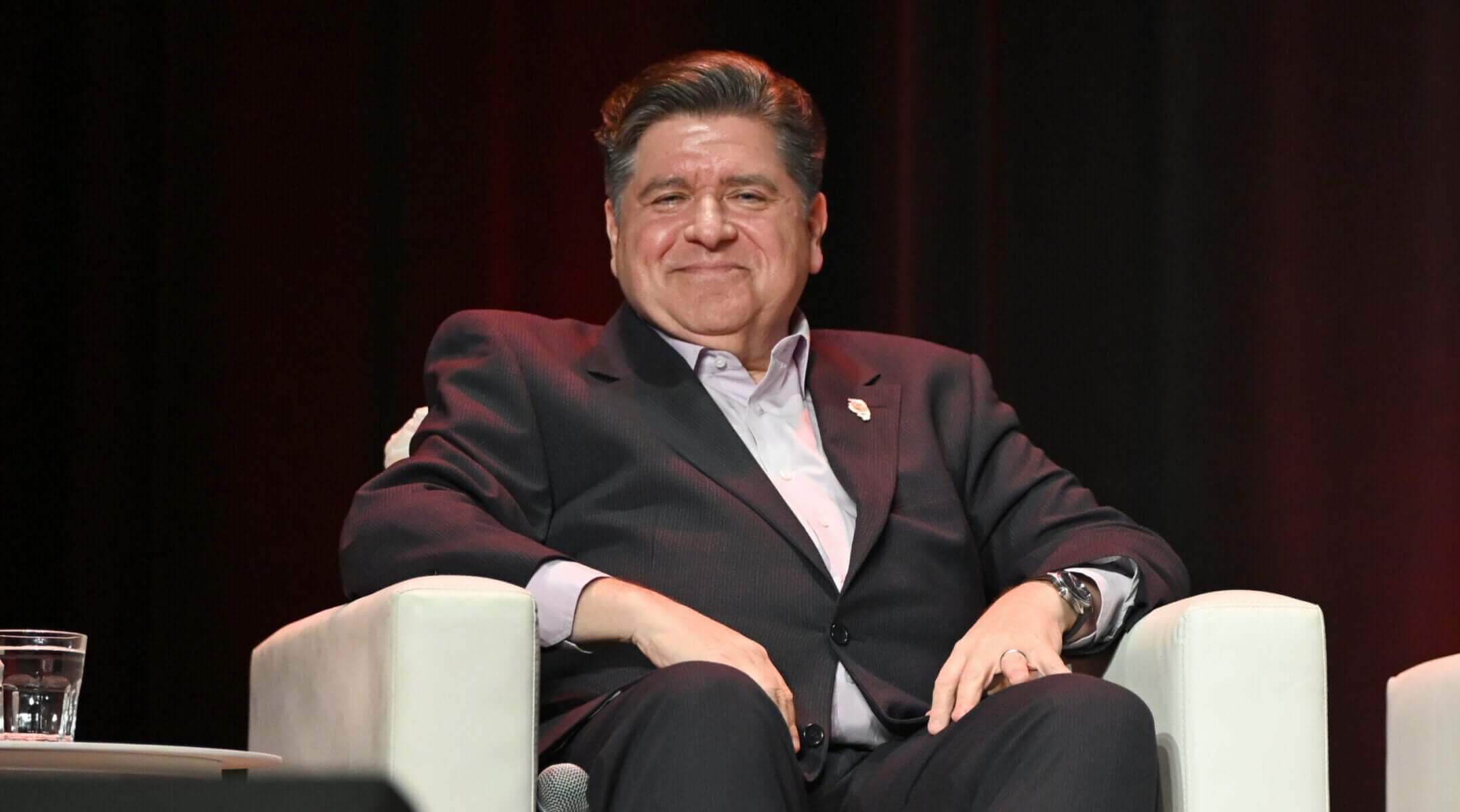 Illinois Gov. JB Pritzker speaks on stage at The Chicago Theatre on November 12, 2025.