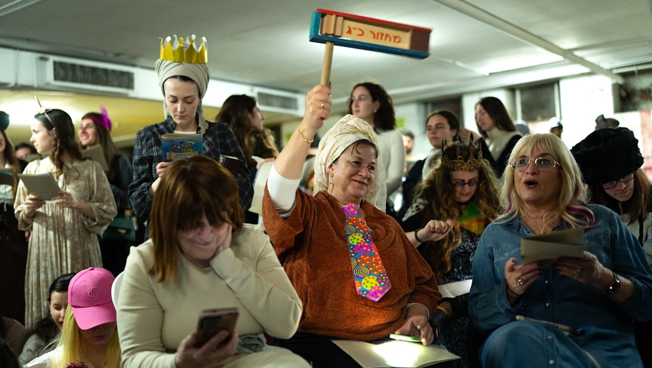 Israelis attend the reading of the Book of Esther in the Dizengoff Center underground parking lot to mark Purim in Tel Aviv, March 2, 2026. The garage served as a bomb shelter as Iran exchanged missiles with Israel.