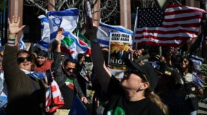 Iranian Americans wave flags and chant during a gathering of Iranian community members showing support for Israel and the United States, outside the Consulate General of Israel in Los Angeles, on March 5, 2026.
