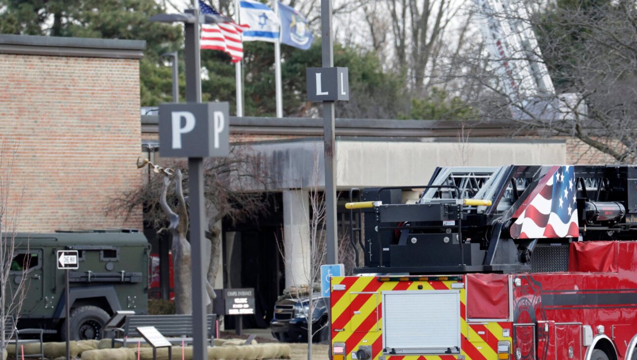 Law enforcement remain on site at the Temple Israel synagogue in West Bloomfield, Michigan, a Detroit suburb, on March 12, 2026, after an assailant drove a vehicle into the building. 