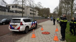 Police officers stand outside a Jewish school where an explosion was reported overnight in Amsterdam on March 14, 2026.