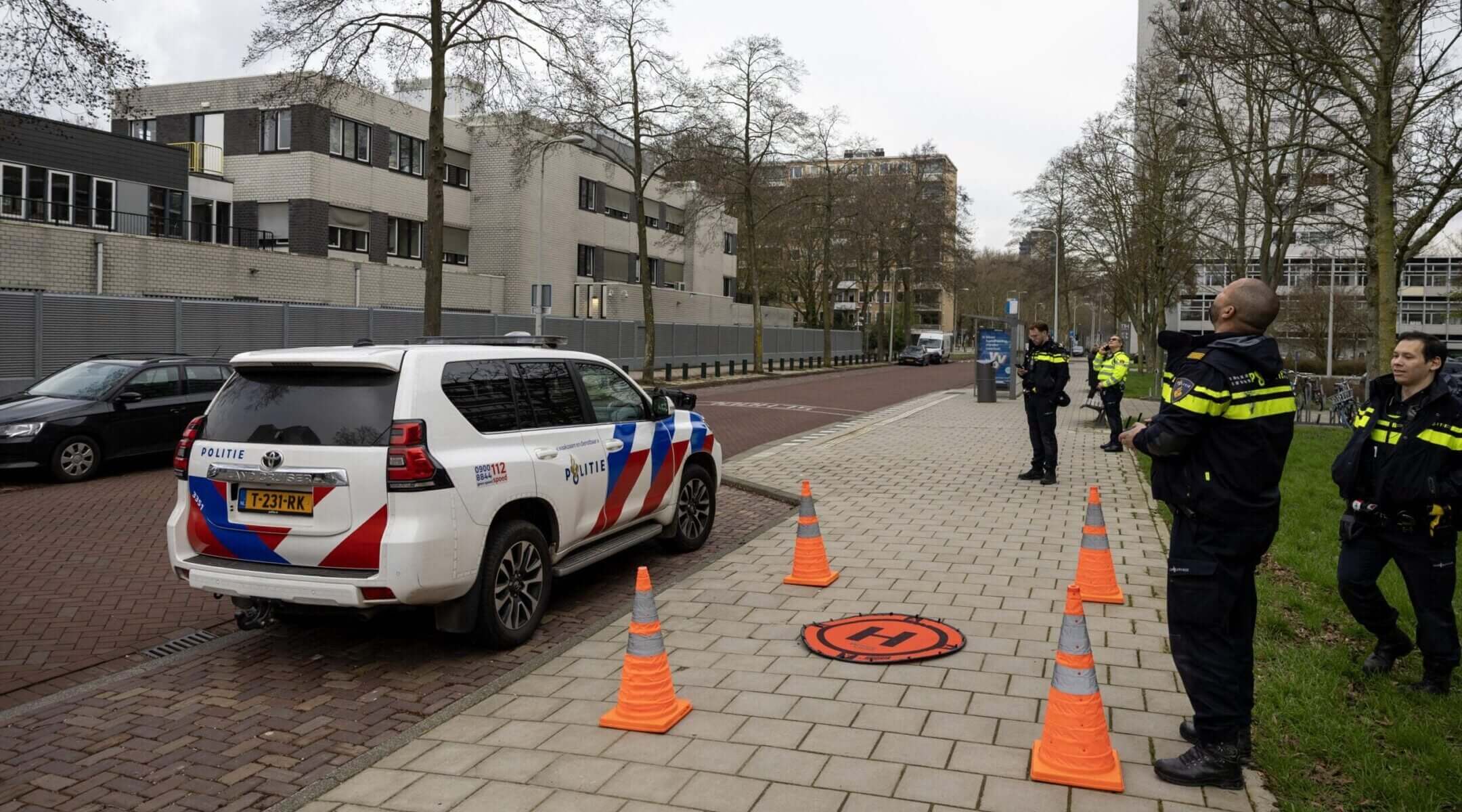 Police officers stand outside a Jewish school where an explosion was reported overnight in Amsterdam on March 14, 2026.