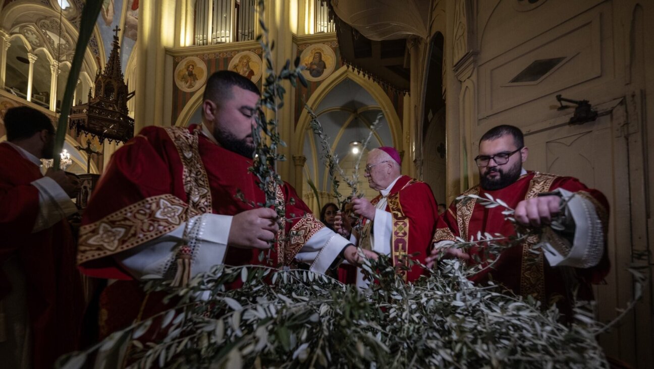 Christians attend a service organized by the Latin Patriarchate to celebrate the feast of Palm Sunday, one of the most important holidays of the Christian calendar, in Jerusalem, March 29, 2026.