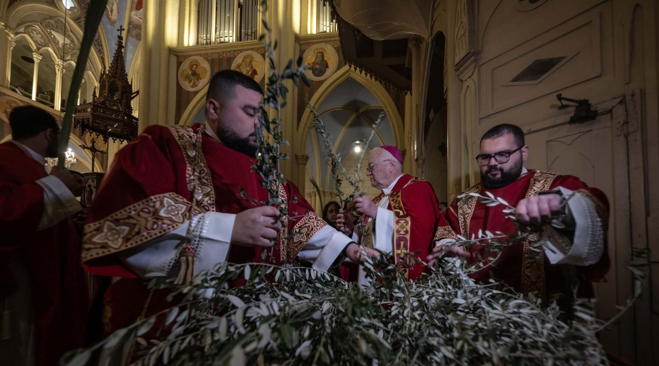 Christians attend a service organized by the Latin Patriarchate to celebrate the feast of Palm Sunday, one of the most important holidays of the Christian calendar, in Jerusalem, March 29, 2026.