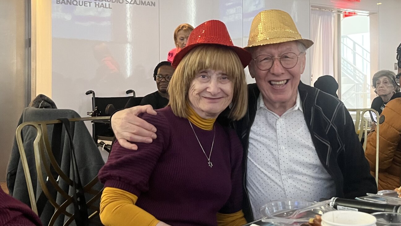 NAHOS president Yossie Finkelstein, right, with wife Lea, at the group's Purim party, March 8, 2026.