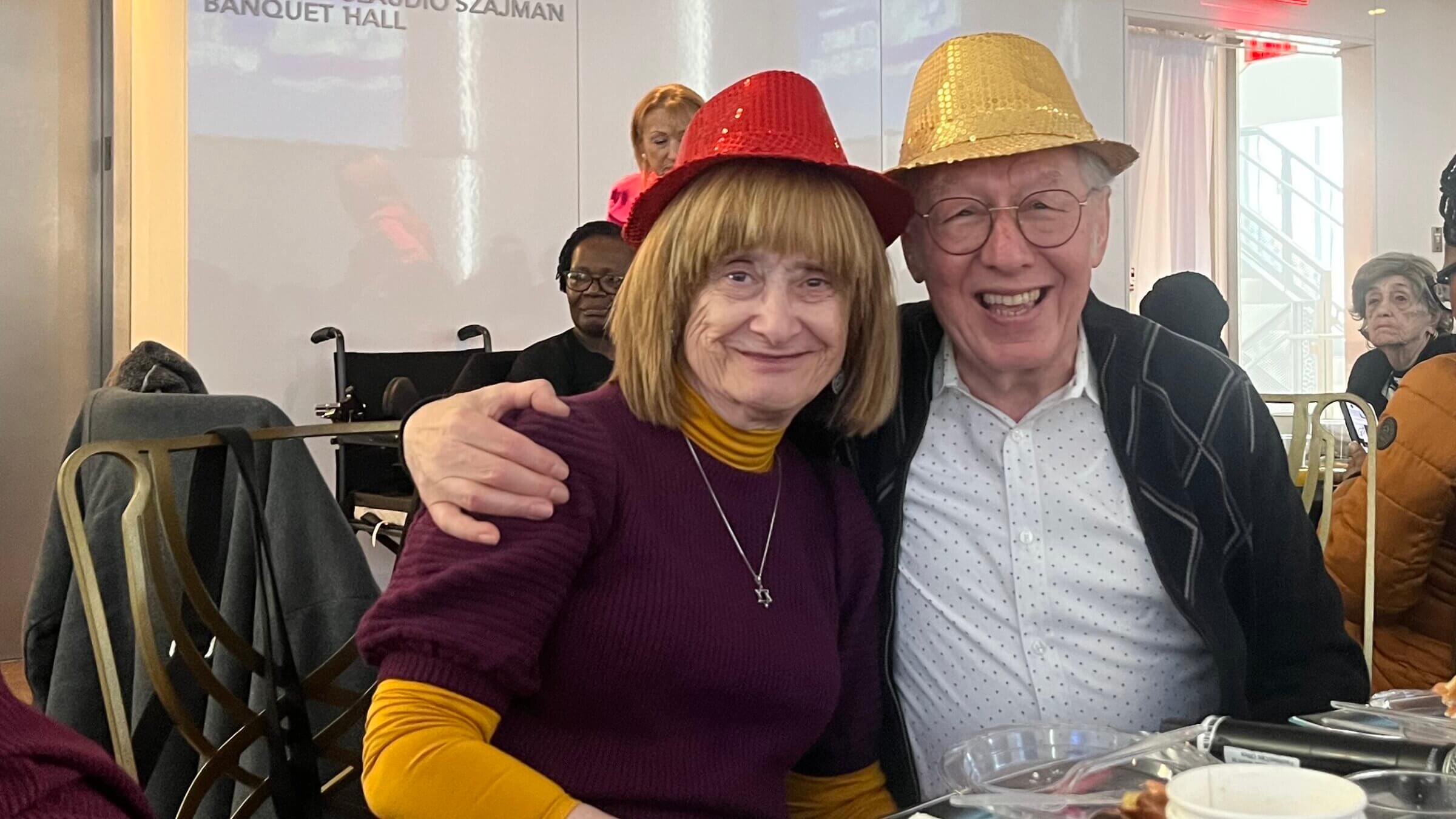 NAHOS president Yossie Finkelstein, right, with wife Lea, at the group's Purim party, March 8, 2026.