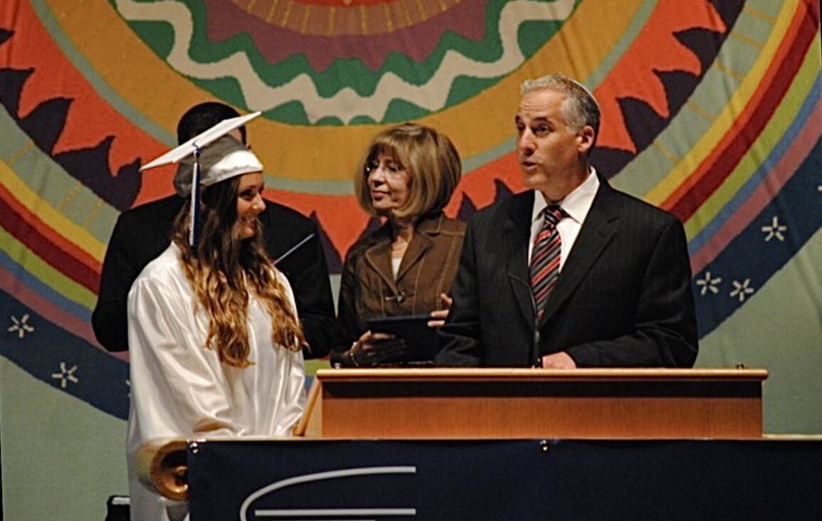 The author, left, with Temple Israel rabbi Josh Bennett, at her graduation from Frankel Jewish Academy in 2011, hosted at Temple Israel. 
