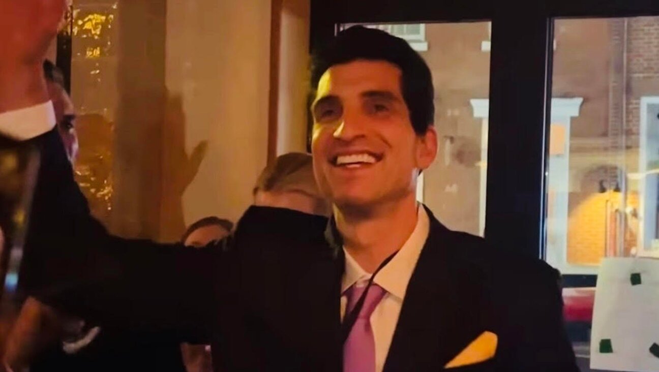 Andrew Ginsburg celebrates after winning a JFK Jr. look-alike competition in the West Village.