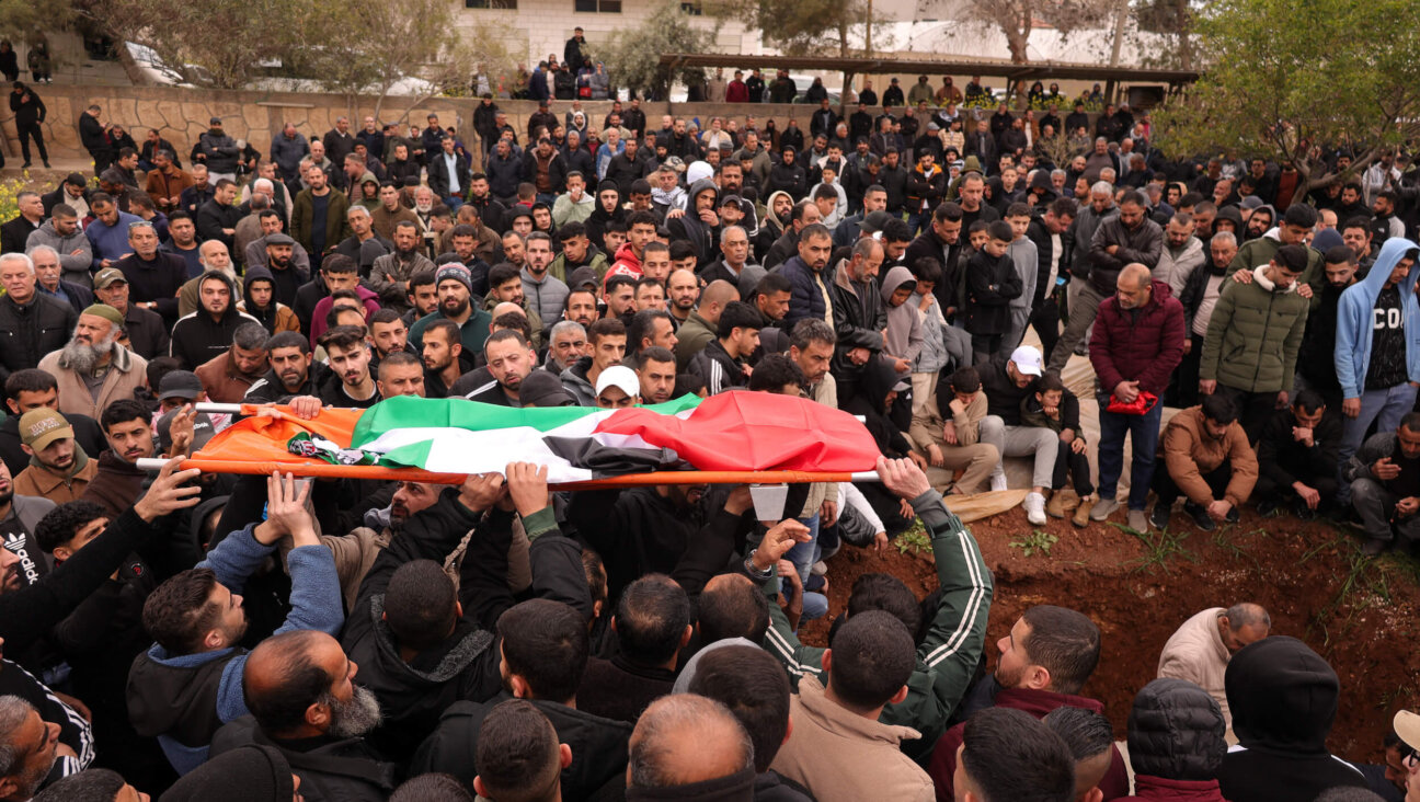 Palestinian mourners carry coffins during the funeral of four members of the Bani Odeh family, who were killed by undercover Israeli soldiers in the occupied West Bank on March 15.