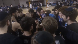 Members of the Yeshiva University Maccabees huddle during their Sweet 16 game against Emory University, March 13, 2026, in Atlanta.