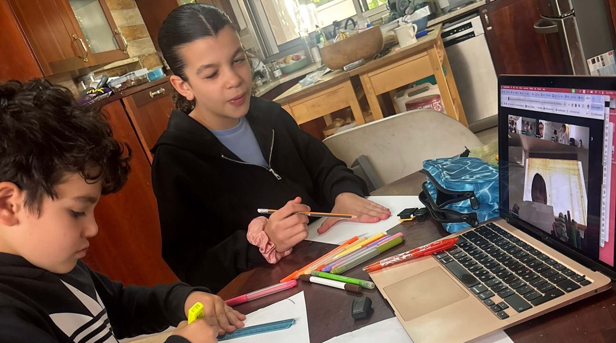 Claire Bloom Moradian’s children participate in a Zoom class while their school is closed during the war with Iran, March 2026. (Courtesy Moradian)