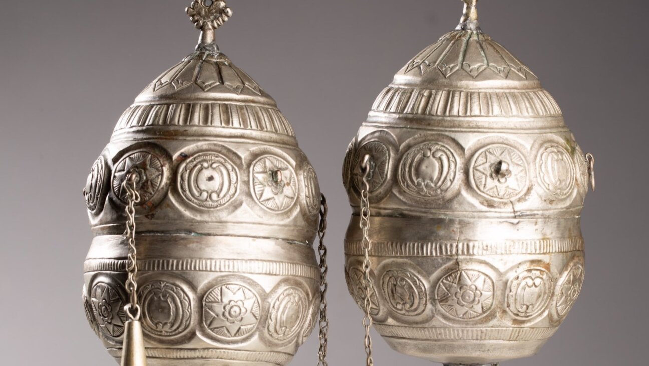 A pair of finials, which adorned the wooden rollers of a Torah scroll, are among the artifacts being returned to Greece.