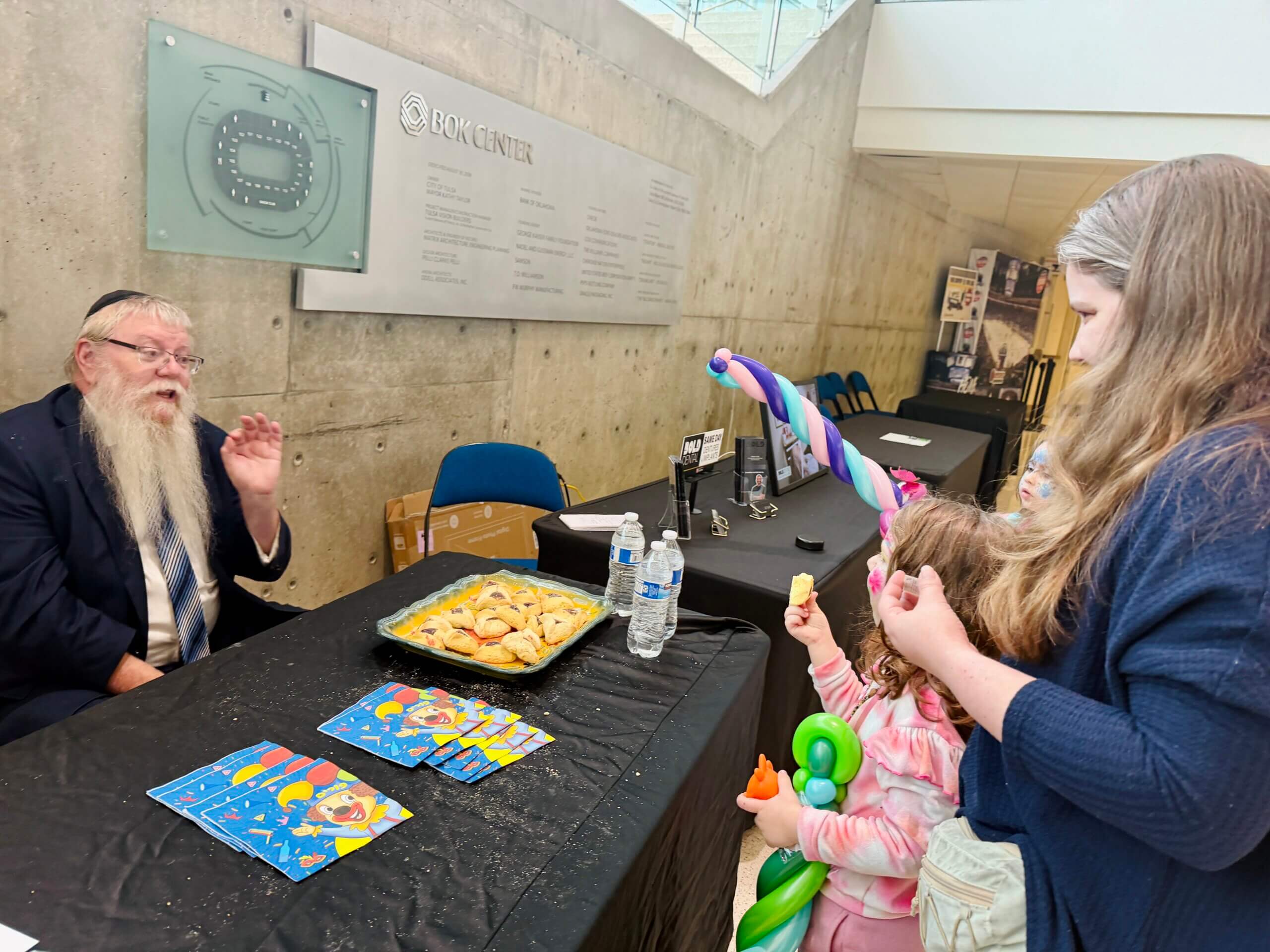 Chabad's Rabbi Yehuda Weg passes out hamantashen at a Tulsa Oilers hockey game.