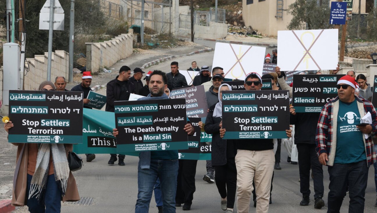 Israelis, foreigners and Palestinians demonstrate in Beit Jala village in the occupied West Bank city of Bethlehem on December 19, 2025, against a bill proposing the death penalty that could apply to Palestinians convicted of deadly attacks against Israelis. (HAZEM BADER / AFP)