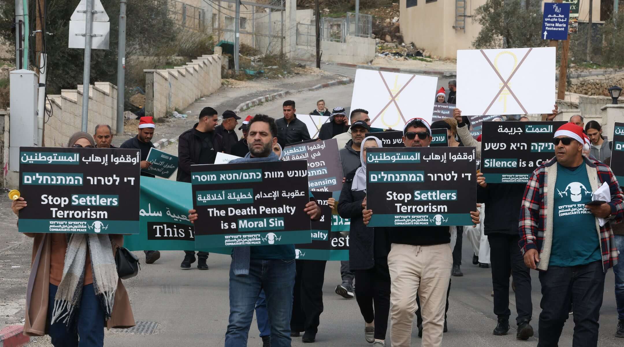 Israelis, foreigners and Palestinians demonstrate in Beit Jala village in the occupied West Bank city of Bethlehem on December 19, 2025, against a bill proposing the death penalty that could apply to Palestinians convicted of deadly attacks against Israelis. (HAZEM BADER / AFP)