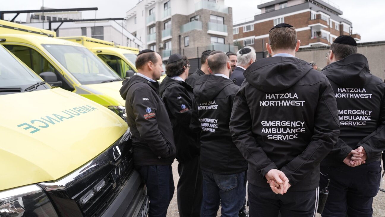 Staff from Hatzola Northwest Emergency Ambulance Service stand alongside the four replacement ambulances, which are on loan from the London Ambulance Service (LAS), at the the Jewish Community Ambulance service in Golders Green, London on March 24, 2026.