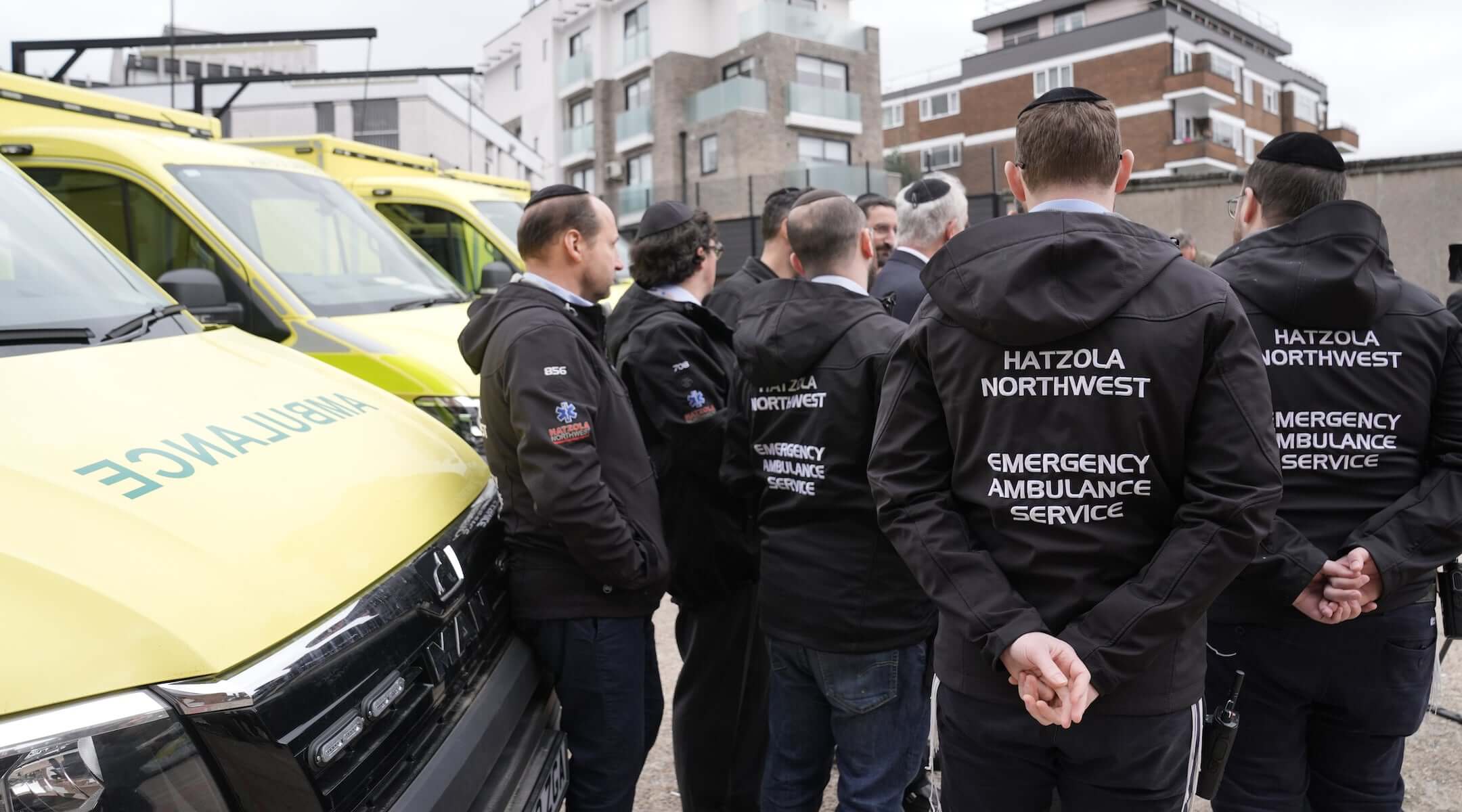 Staff from Hatzola Northwest Emergency Ambulance Service stand alongside the four replacement ambulances, which are on loan from the London Ambulance Service (LAS), at the the Jewish Community Ambulance service in Golders Green, London on March 24, 2026.