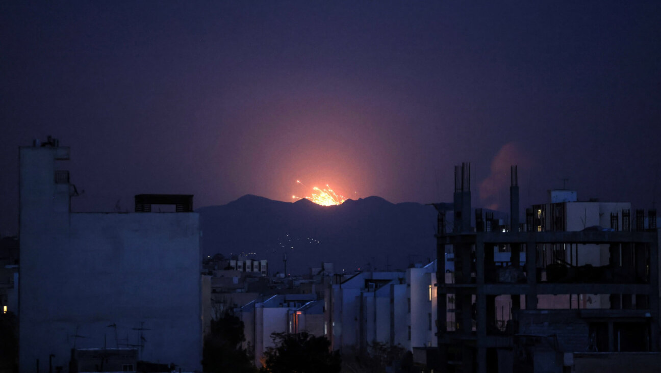 The sky is lit up at the site of an airstrikes in a central area of the Iranian capital Tehran on March 6.