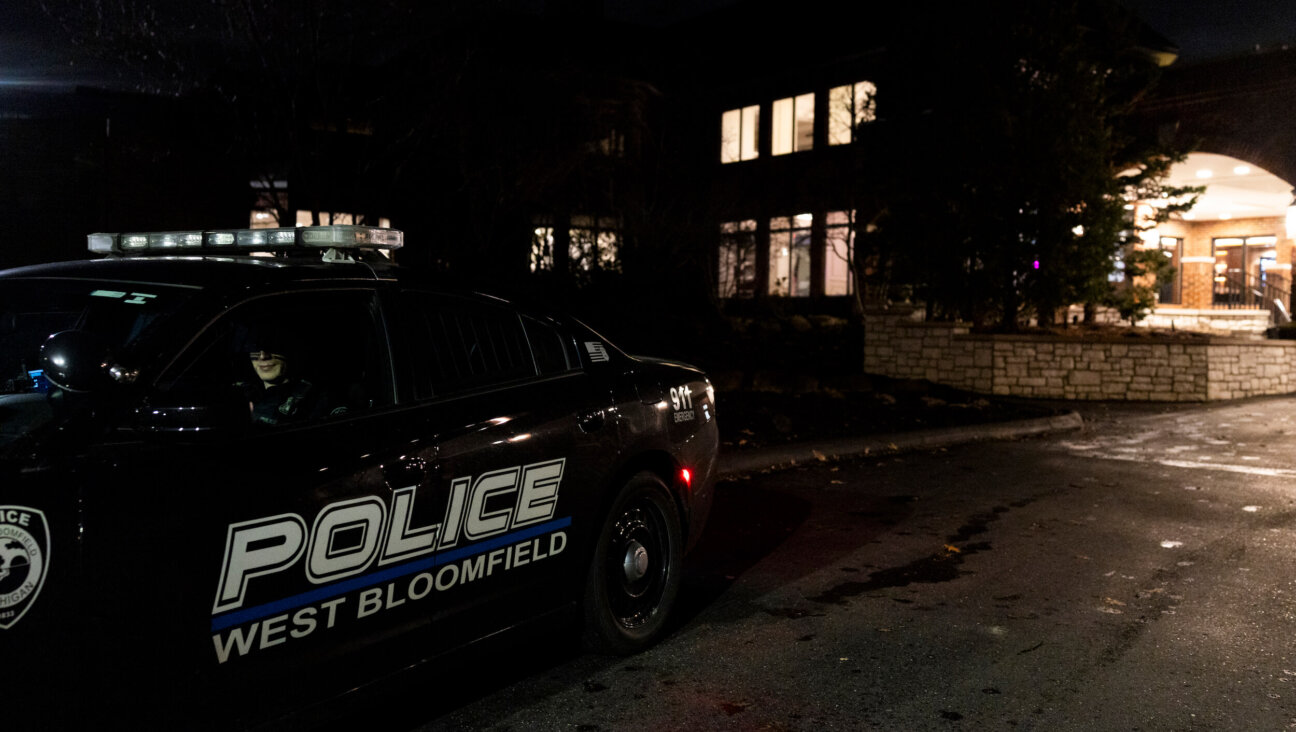 A police officer patrols outside of a Bat Mitzvah at Tam O'Shanter Country Club on March 13 in West Bloomfield, Michigan. The ceremony was moved from Temple Israel after a gunman rammed a vehicle into the synagogue and opened fire on Thursday.