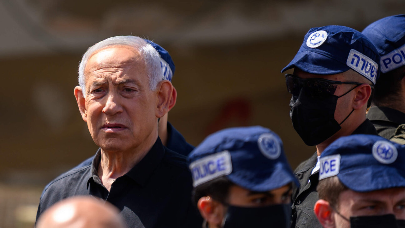 Israeli Prime Minister Benjamin Netanyahu visits an area destroyed by an Iranian ballistic missile in Dimona, Israel — leaving more than 50 wounded — on March 22.