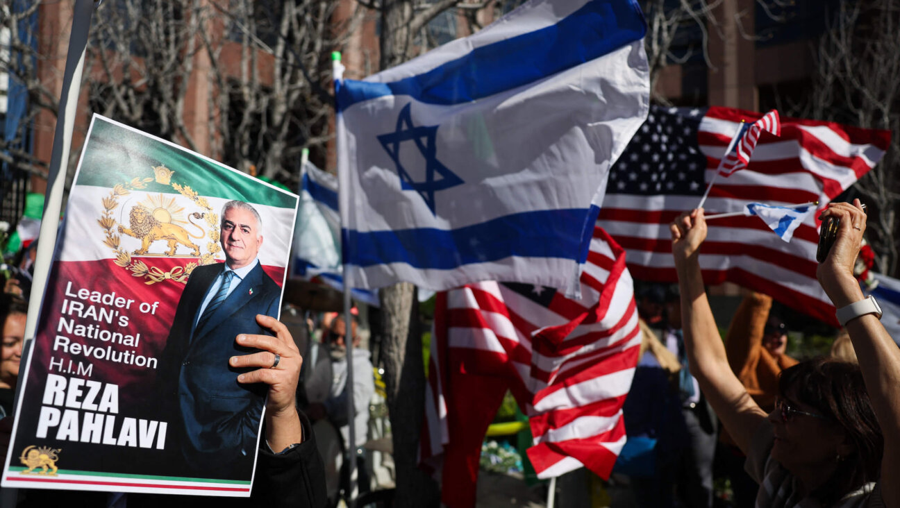 People hold signs in support of Reza Pahlavi, son of the last shah of Iran, during a gathering of Iranian community members showing support for Israel and the United States, outside the Consulate General of Israel in Los Angeles, on March 5.