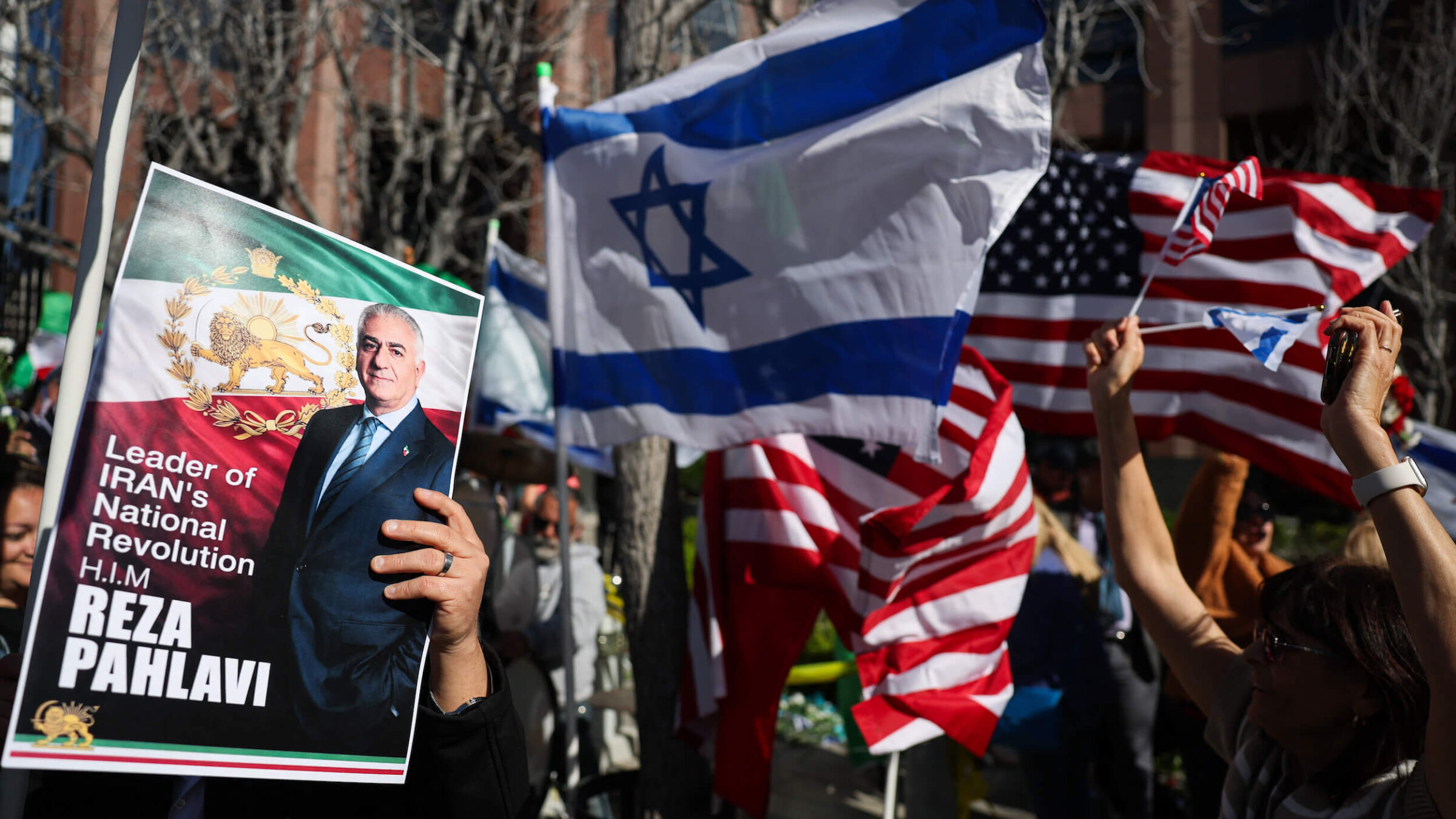 People hold signs in support of Reza Pahlavi, son of the last shah of Iran, during a gathering of Iranian community members showing support for Israel and the United States, outside the Consulate General of Israel in Los Angeles, on March 5.