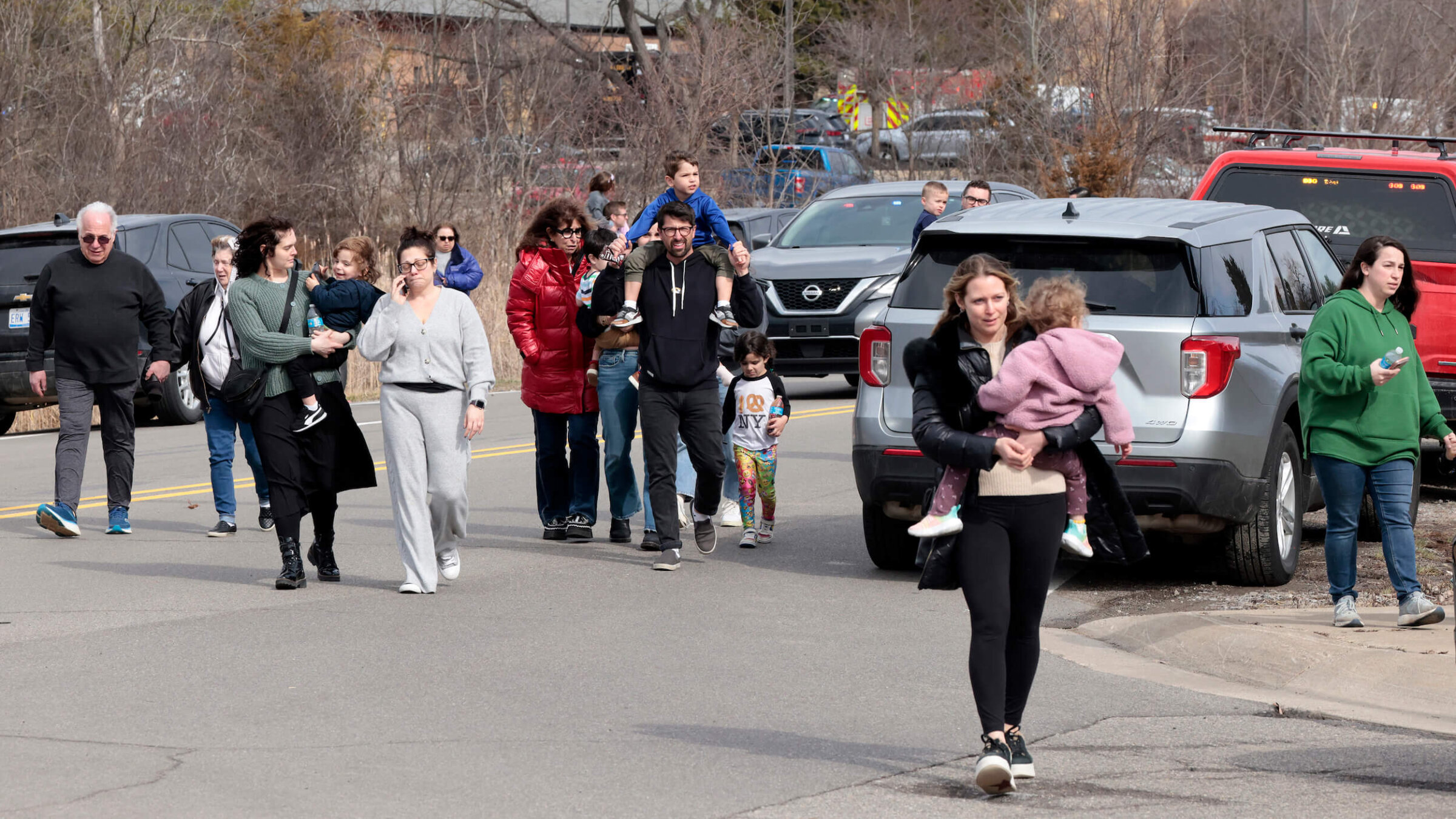 Families leave after being reunited outside Temple Israel synagogue on Thursday.