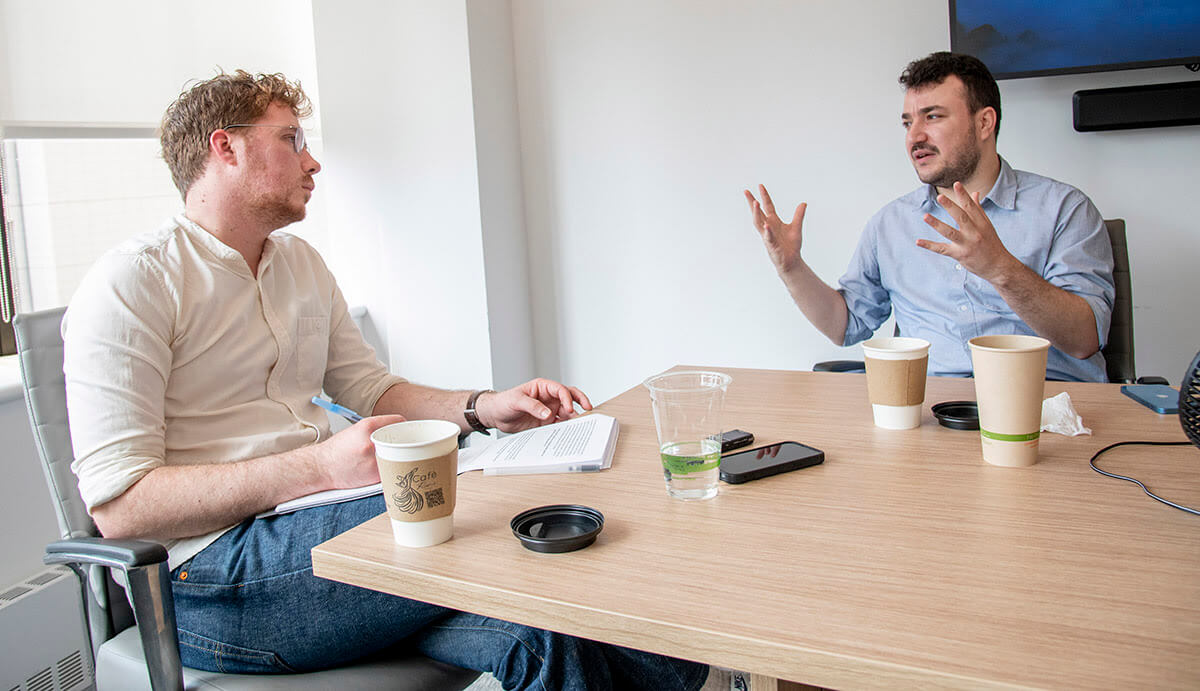 The Forward’s Arno Rosenfeld, left, interviews Mahmoud Khalil last week in Manhattan.